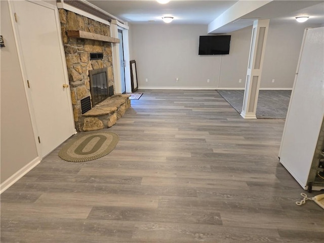 33295 Bethel Church Rd, Osawatomie, KS 66064 - finished below grade area with wood finished floors, a stone fireplace, and baseboards