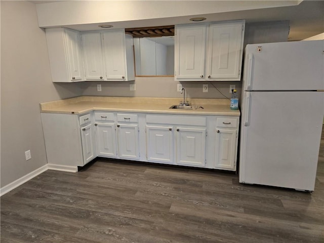 33295 Bethel Church Rd, Osawatomie, KS 66064 - kitchen featuring freestanding refrigerator, a sink, dark wood-style flooring, white cabinets, and light countertops