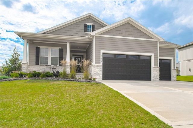 11410 Bluestem Dr, Kearney, MO 64060 - craftsman-style house with stone siding, a garage, and a front lawn