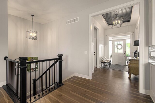 11410 Bluestem Dr, Kearney, MO 64060 - foyer entrance with a chandelier, dark wood-style floors, and baseboards