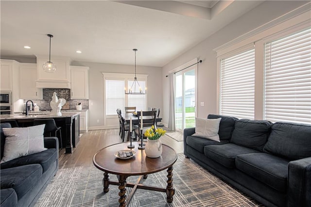 11410 Bluestem Dr, Kearney, MO 64060 - living room featuring wood finished floors, recessed lighting, and baseboards