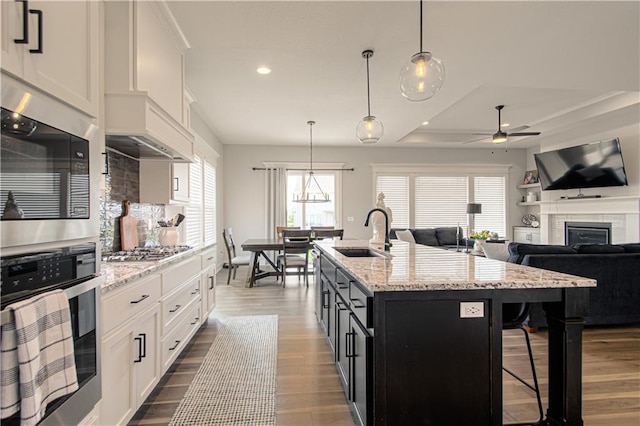 11410 Bluestem Dr, Kearney, MO 64060 - kitchen with a sink, appliances with stainless steel finishes, ceiling fan, white cabinetry, and recessed lighting