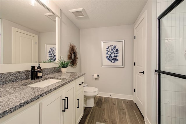 11410 Bluestem Dr, Kearney, MO 64060 - full bath featuring wood finished floors, toilet, vanity, baseboards, and a textured ceiling