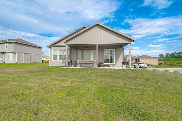 11410 Bluestem Dr, Kearney, MO 64060 - back of house with ceiling fan, a yard, a patio area, and an outdoor hangout area