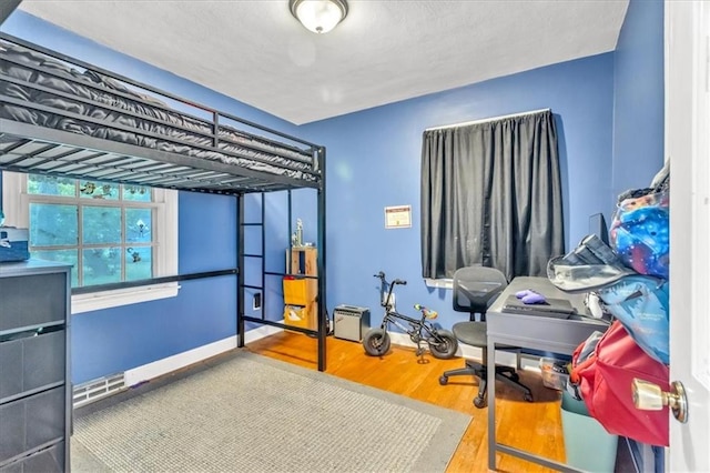 1317 W 29th Ter, Independence, MO 64052 - bedroom with wood finished floors and baseboards