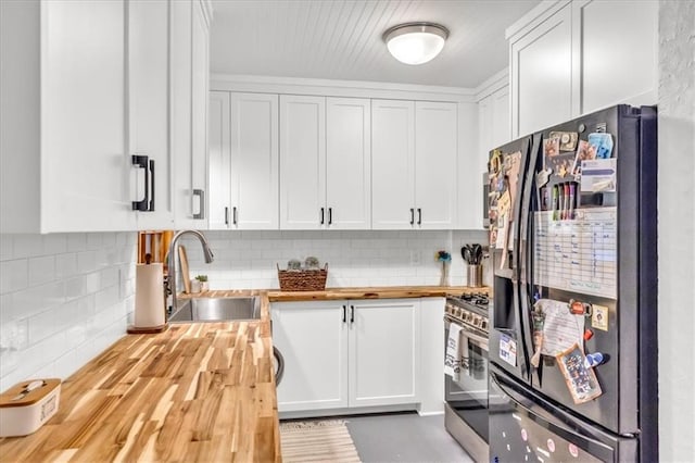 1317 W 29th Ter, Independence, MO 64052 - kitchen with fridge with ice dispenser, wooden counters, a sink, stainless steel gas range, and tasteful backsplash