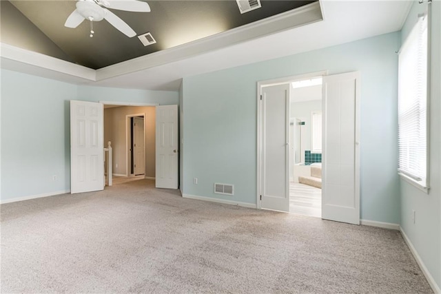 4901 NW 87th St, Kansas City, MO 64154 - unfurnished bedroom featuring carpet floors, vaulted ceiling, baseboards, connected bathroom, and a ceiling fan