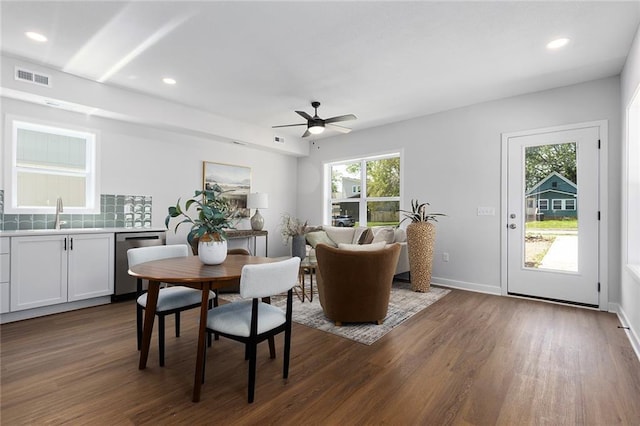 dining space with dark wood finished floors, a ceiling fan, recessed lighting, and baseboards