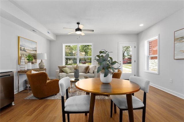 dining room with a ceiling fan, light wood-type flooring, baseboards, and recessed lighting