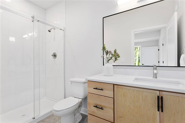 bathroom with toilet, a shower stall, vanity, and tile patterned flooring