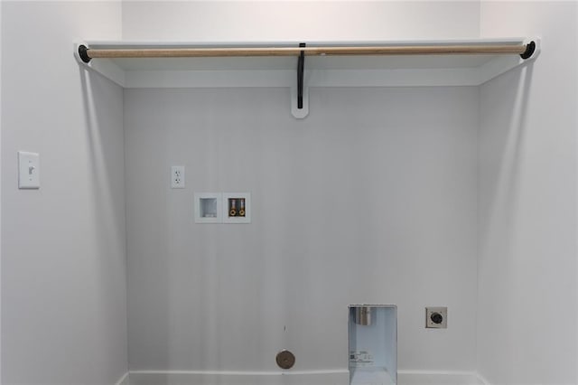 clothes washing area with hookup for an electric dryer, hookup for a washing machine, and baseboards