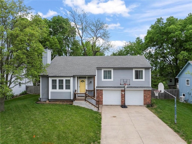 15328 W 81st St, Lenexa, KS 66219 - split level home with a garage, driveway, a chimney, and brick siding