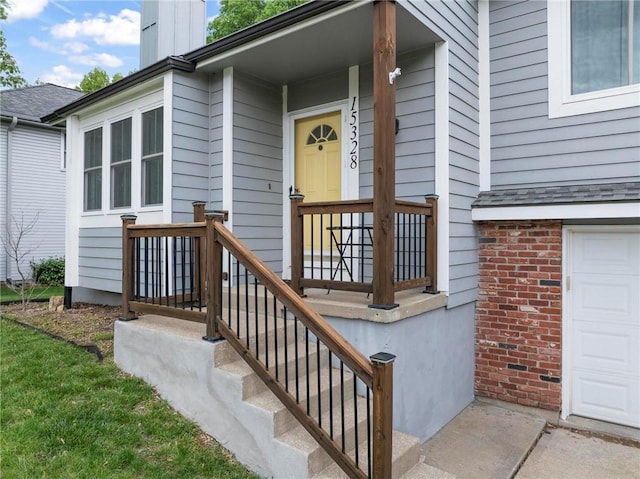 15328 W 81st St, Lenexa, KS 66219 - entrance to property with a chimney, a garage, and brick siding