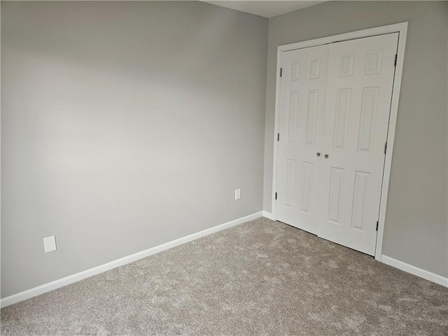 1309 Thomas Dr, Louisburg, KS 66053 - unfurnished bedroom featuring carpet flooring, a closet, and baseboards
