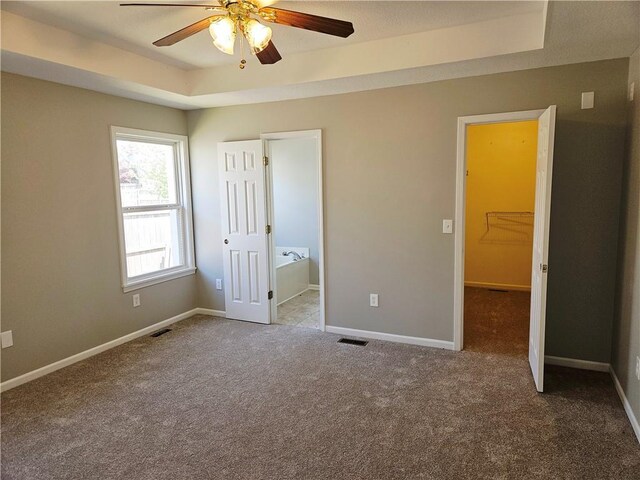 1309 Thomas Dr, Louisburg, KS 66053 - unfurnished bedroom with a raised ceiling, carpet floors, and baseboards
