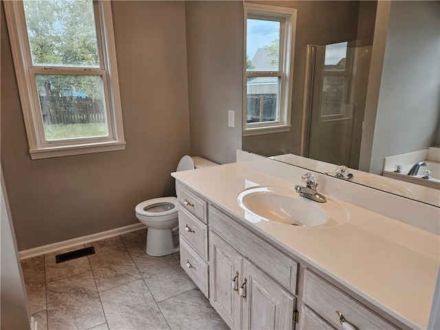 1309 Thomas Dr, Louisburg, KS 66053 - bathroom with vanity, healthy amount of natural light, toilet, and baseboards
