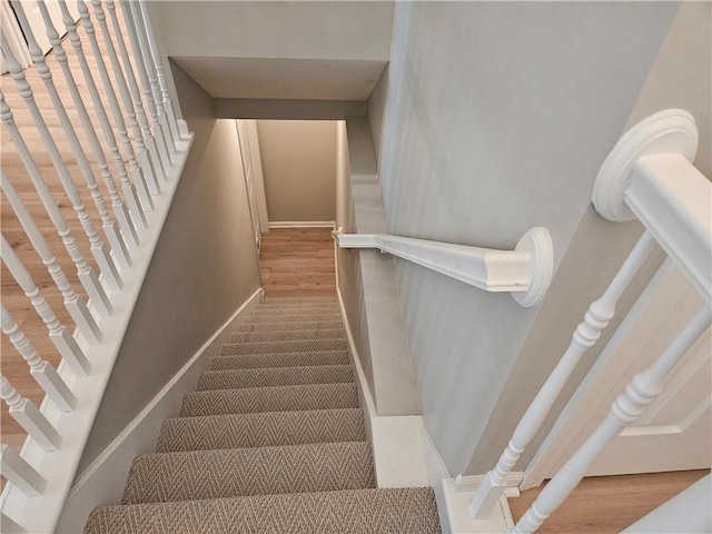 1309 Thomas Dr, Louisburg, KS 66053 - stairs with baseboards and wood finished floors
