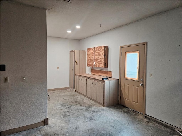 1309 Thomas Dr, Louisburg, KS 66053 - kitchen featuring light countertops, a textured wall, and baseboards