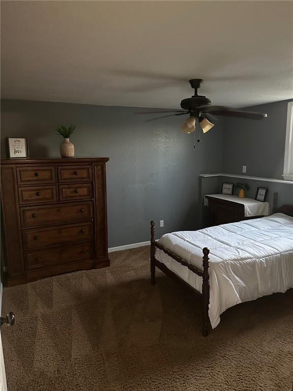 bedroom featuring carpet flooring, a ceiling fan, and baseboards