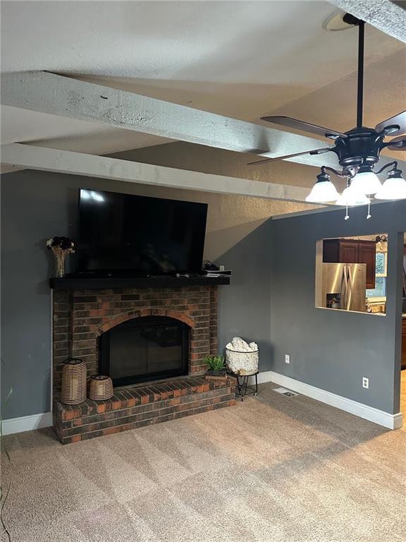 carpeted living room featuring a fireplace, ceiling fan, and baseboards