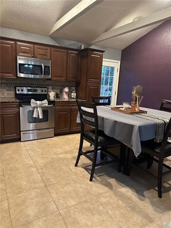 kitchen with stainless steel appliances, a textured ceiling, backsplash, and dark brown cabinetry