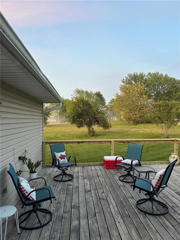 wooden terrace with a lawn