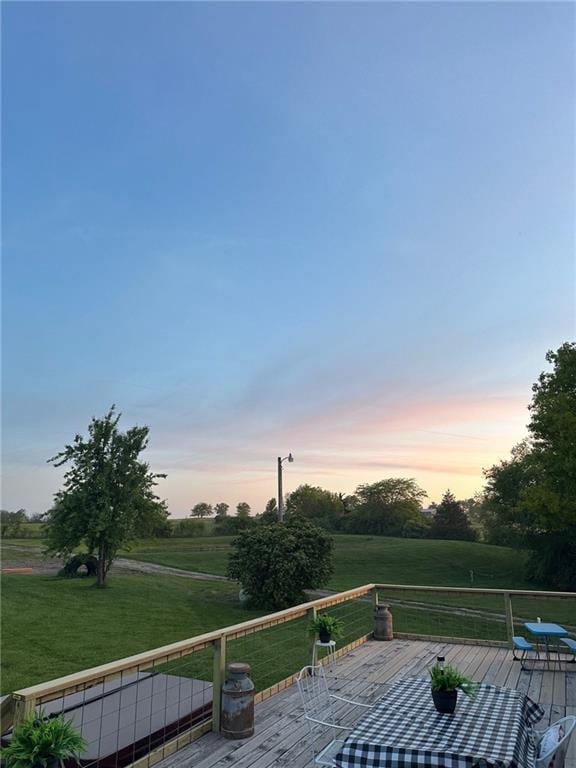 deck with a yard and a view of rural / pastoral area