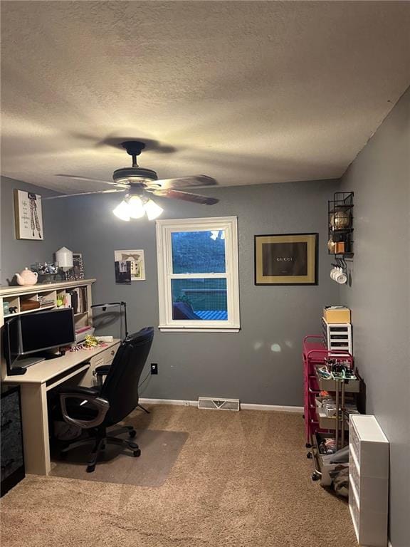 home office featuring carpet floors, ceiling fan, a textured ceiling, and baseboards
