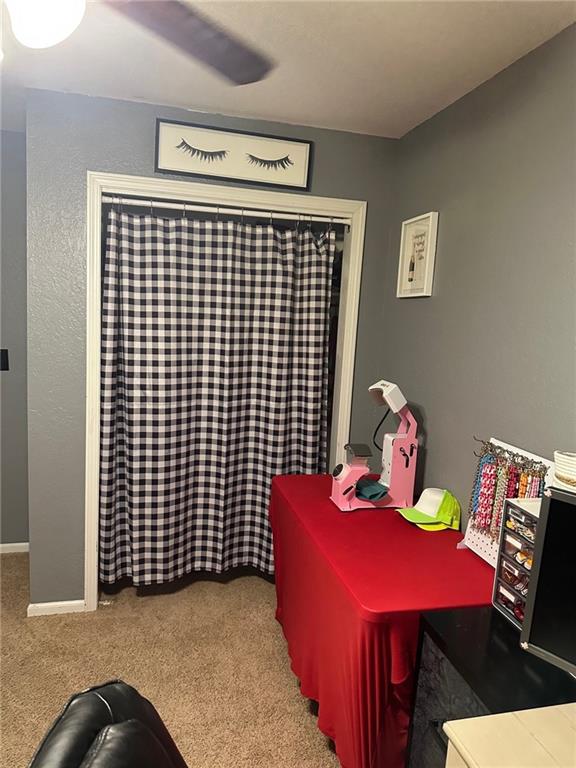 carpeted office space with baseboards