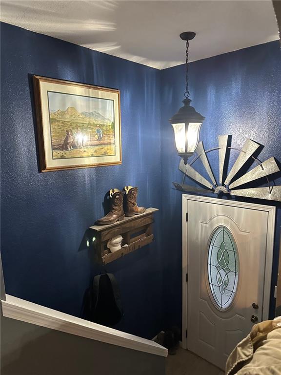 foyer entrance featuring a textured wall