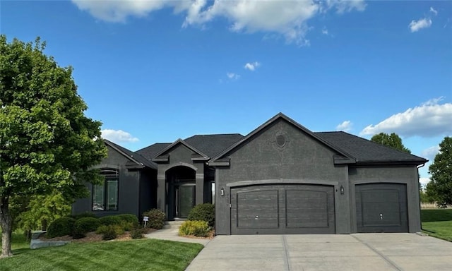 4301 N 141st St, Basehor, KS 66007 - view of front of property featuring a garage, driveway, a front yard, and stucco siding