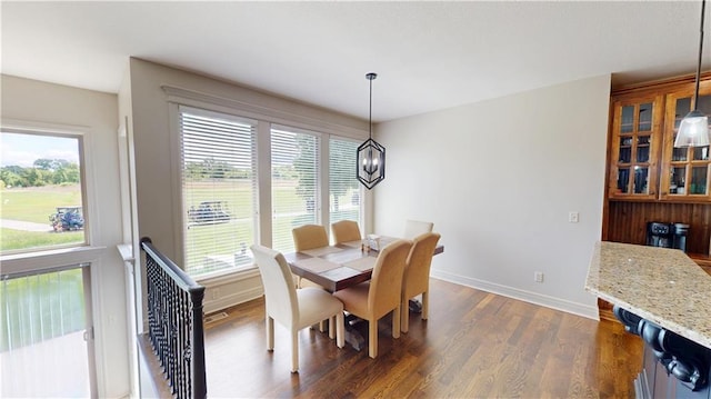 4301 N 141st St, Basehor, KS 66007 - dining space with baseboards, dark wood-style flooring, and a chandelier