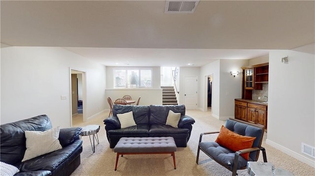 4301 N 141st St, Basehor, KS 66007 - living room featuring light colored carpet, stairs, and baseboards