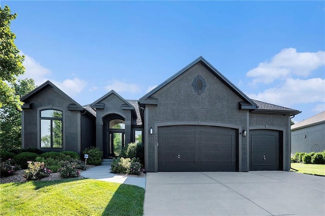 4301 N 141st St, Basehor, KS 66007 - view of front of house featuring a garage, concrete driveway, stucco siding, and a front lawn