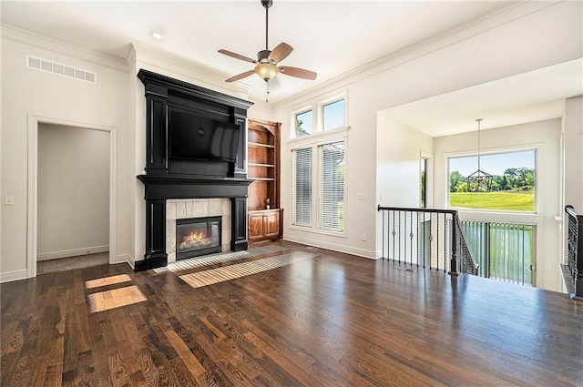4301 N 141st St, Basehor, KS 66007 - unfurnished living room featuring healthy amount of natural light, a fireplace, dark wood-style flooring, ornamental molding, and a ceiling fan