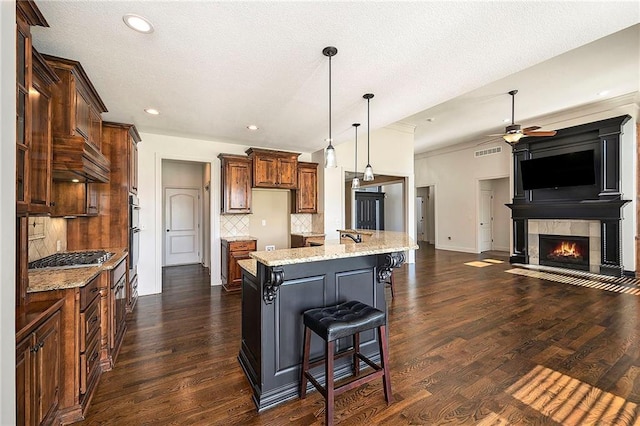 4301 N 141st St, Basehor, KS 66007 - kitchen with a ceiling fan, stainless steel appliances, open floor plan, decorative backsplash, and a tiled fireplace