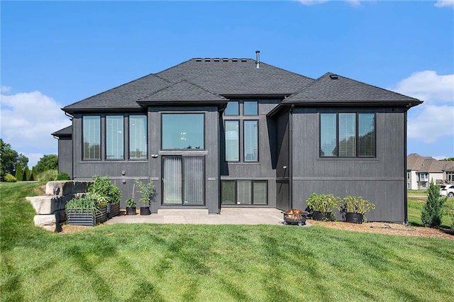 4301 N 141st St, Basehor, KS 66007 - rear view of property with a lawn, roof with shingles, and a fire pit