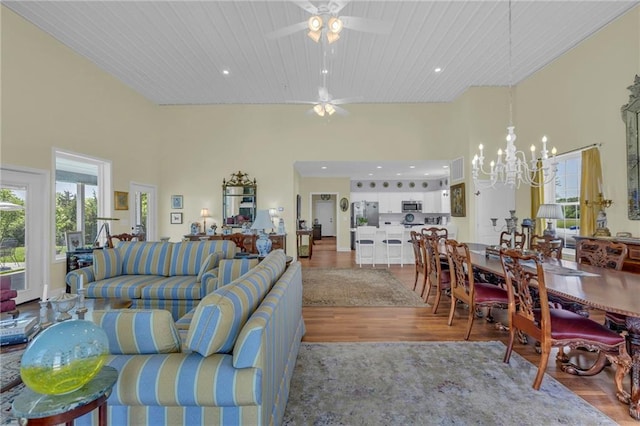 living area with wood finished floors, a chandelier, recessed lighting, wooden ceiling, and a ceiling fan