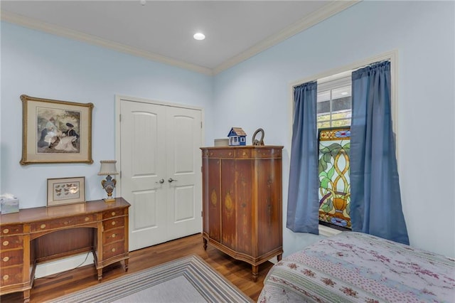 bedroom featuring ornamental molding and wood finished floors