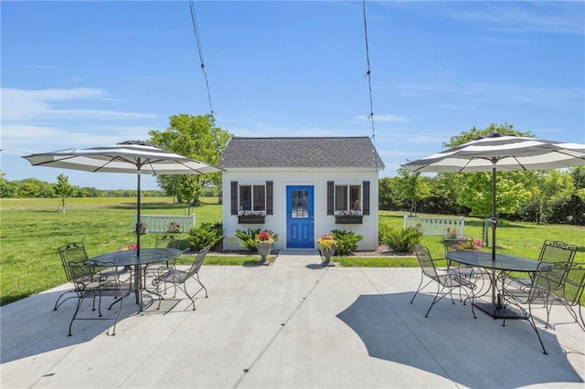view of patio / terrace with outdoor dining space and an outdoor structure