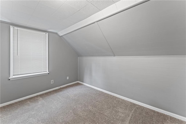 bonus room featuring carpet, lofted ceiling, and baseboards