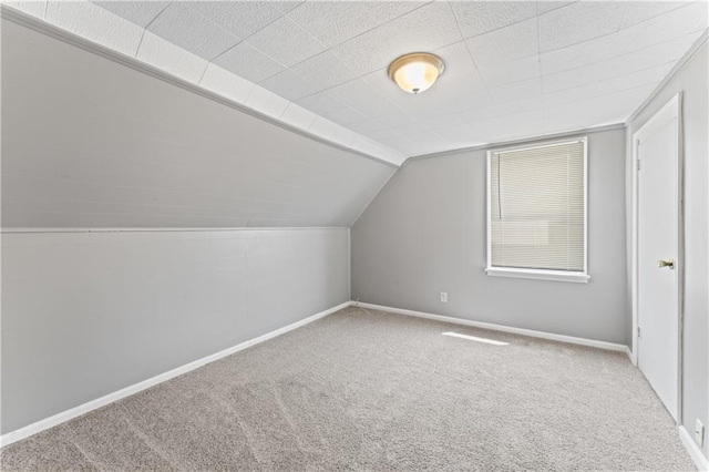 bonus room with carpet flooring, baseboards, and vaulted ceiling
