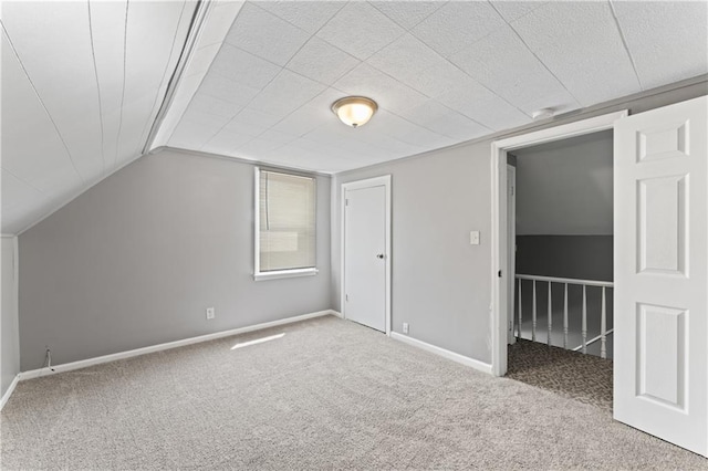bonus room featuring carpet flooring and baseboards