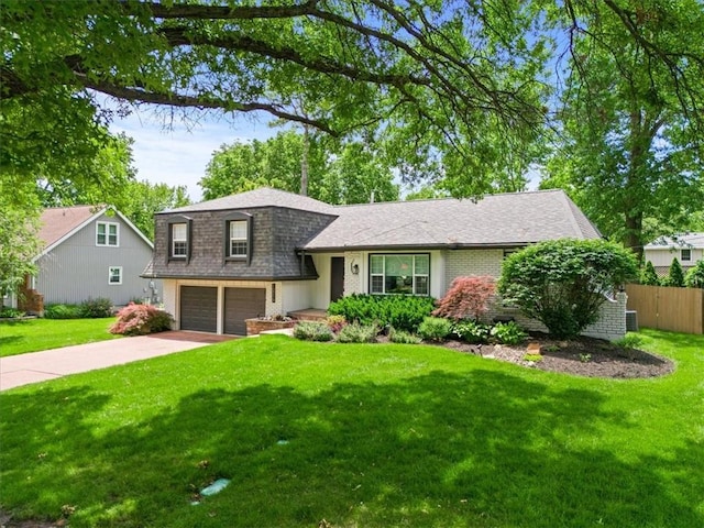 10319 W 92nd Pl, Overland Park, KS 66214 - tri-level home featuring an attached garage, concrete driveway, roof with shingles, and brick siding
