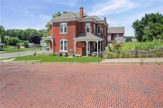 432 S 5th St, Atchison, KS 66002 - italianate home featuring a chimney, a front lawn, and brick siding