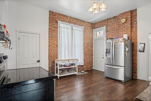 432 S 5th St, Atchison, KS 66002 - kitchen with stainless steel fridge with ice dispenser, brick wall, and dark wood-type flooring
