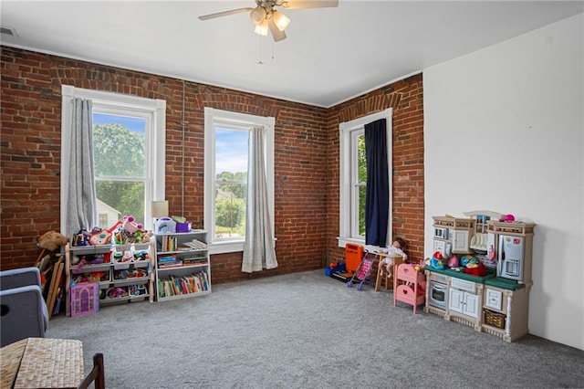 432 S 5th St, Atchison, KS 66002 - playroom with brick wall, carpet, and ceiling fan