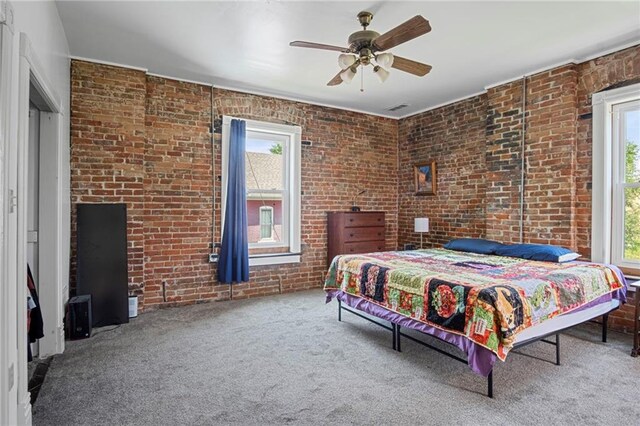 432 S 5th St, Atchison, KS 66002 - carpeted bedroom with brick wall and a ceiling fan