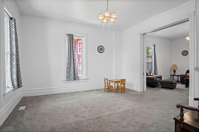 432 S 5th St, Atchison, KS 66002 - living room with carpet flooring, ornamental molding, and a chandelier