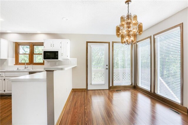 6503 NW Sioux Ct, Parkville, MO 64152 - kitchen featuring black microwave, white cabinets, dark wood finished floors, and recessed lighting